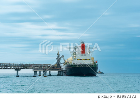liquefied natural gas carrier tanker during loading at an LNG offshore terminal, in the distance the oil export terminal is visible in the sea 92987372