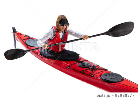 Water sport activities. Athlete in red canoe, kayak with a life vest and a paddle isolated on white background. Concept of sport, nature, travel, active lifestyle 92988577