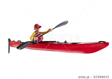 Beginner kayaker in red canoe, kayak with a life vest and a paddle isolated on white background. Concept of sport, nature, travel, active lifestyle 92988642