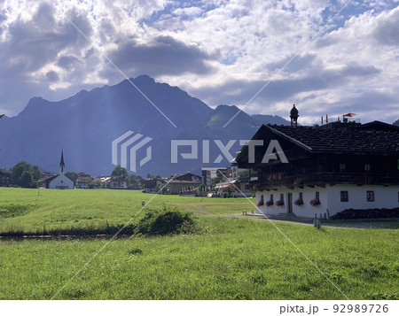The traditional Fischergut and the church illuminated by the ray of light 92989726
