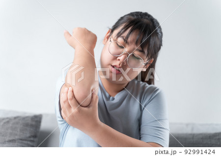 Closeup female's elbow. Arm pain and injury. Health care and medical concept. Closeup female's elbow. Arm pain and injury. Health care and medical concept. 92991424