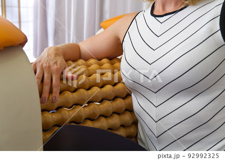 woman making massage for hand. Roll Massage machine is a way to shape the figure. Skin Care, body care concept. modern relax massage equipment. woman making massage for hand. Roll Massage machine is a way to shape the figure. Skin Care, body care concept. modern relax massage equipment. 92992325