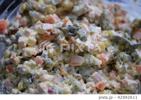 Traditional Russian Olivier salad of boiled sausage pickled green peas, eggs and mayonnaise Traditional Russian Olivier salad of boiled sausage pickled green peas, eggs and mayonnaise 92992611