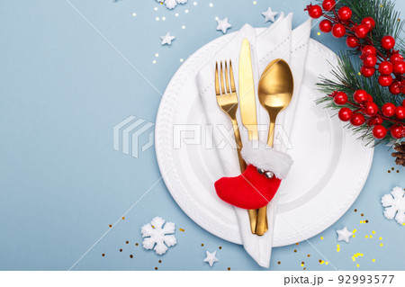 Christmas or new year table setting with golden cutlery Christmas or new year table setting with golden cutlery 92993577