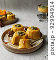 Pumpkin pannacotta with seeds on a gray background. 92994914