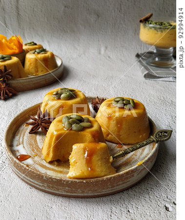 Pumpkin pannacotta with seeds on a gray background. Pumpkin pannacotta with seeds on a gray background. 92994914