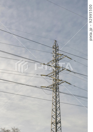 Electric pole metal truss with wires against a cloudy sky. Electric pole metal truss with wires against a cloudy sky. 92995500