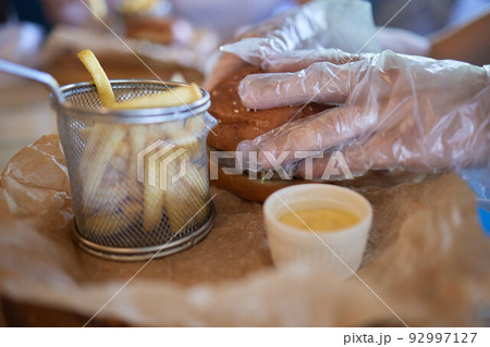 Burger with mushrooms, meatballs, tomato and lettuce on wooden background. Close up. 92997127