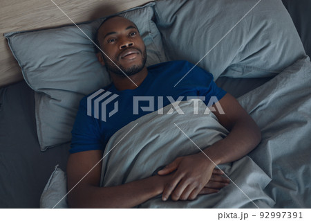 African American Man Lying In Bed Awake Having Insomnia Indoors 92997391