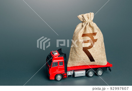 Truck with a indian rupee money bag. Loan or deposit. Financial aid, investments and subsidies. High super income. Payment of taxes. Debt load. Money transfers and transactions. Compensation. 92997607