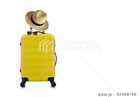 Travelling concept with yellow luggage with hat and yellow sun glasses isolated on white background 92998706