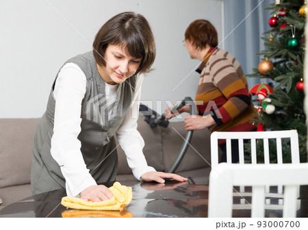 Friendly family tidying up the room before Christmas Friendly family tidying up the room before Christmas 93000700