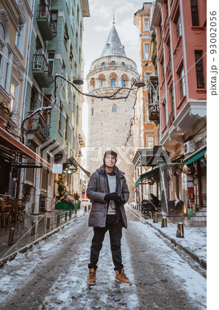asian man standing in the city of istanbul during snow 93002056