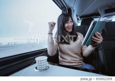 suprised young woman cover her mouth while looking at her mobile phone suprised young woman cover her mouth while looking at her mobile phone 93002209