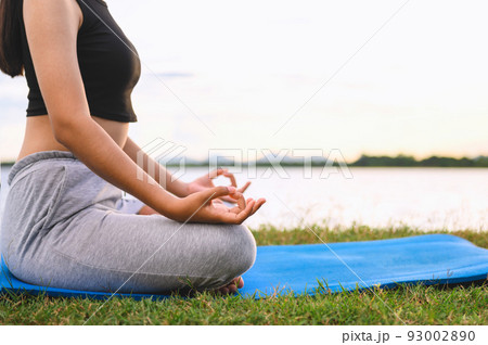 Woman Yoga sitting  near river  nature sunset 93002890