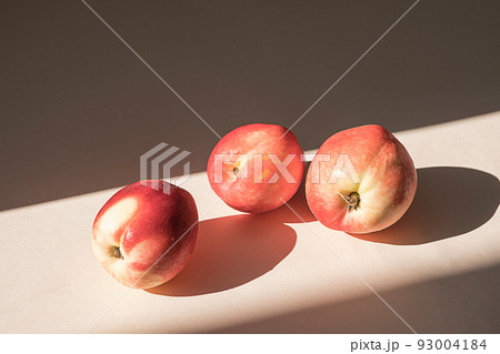Peaches in sunlight. Minimalism, trendy still life with shadow. Peaches in sunlight. Minimalism, trendy still life with shadow. 93004184