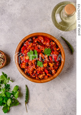 Chili Con Carne in bowl on grey background. Chili Con Carne in bowl on grey background. 93004749