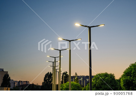 A modern street LED lighting pole. Urban electro-energy technologies. A row of street lights against the night sky A modern street LED lighting pole. Urban electro-energy technologies. A row of street lights against the night sky 93005768