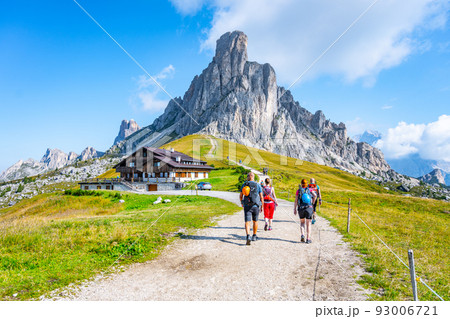 Group of hikers walks towards mountains Group of hikers walks towards mountains 93006721