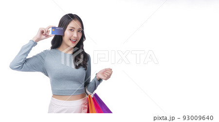Excited asian showing credit card holding shopping bags in arm standing white background. Cheerful Excited asian showing credit card holding shopping bags in arm standing white background. Cheerful 93009640