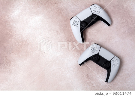 Two game controllers on a light background. White joystick for computer games top view. 93011474