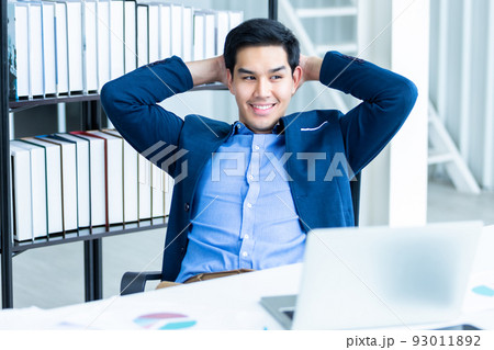 Very Happy of successful asian young businessman on laptop computer, Smartphone and pencil on notebook In the office room background. Very Happy of successful asian young businessman on laptop computer, Smartphone and pencil on notebook In the office room background. 93011892