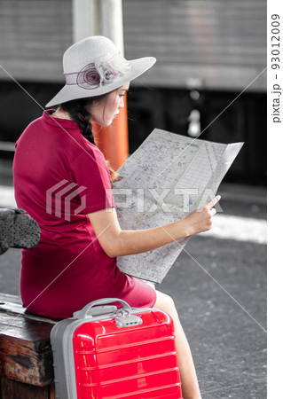 Asian woman pregnant in red dress carrying red luggage and look at the map at railway station travel,traveler with backpack in summer Holiday concept Thailand Asian woman pregnant in red dress carrying red luggage and look at the map at railway station travel,traveler with backpack in summer Holiday concept Thailand 93012009