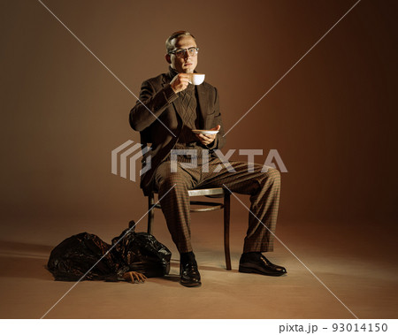Retro style portrait of young man, writer and traveler wearing vintage style clothes isolated over dark brown background. Business, art, fashion concept 93014150