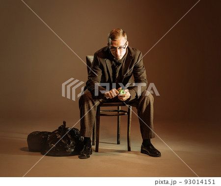 Retro style portrait of young man, writer and traveler wearing vintage style clothes isolated over dark brown background. Business, art, fashion concept 93014151