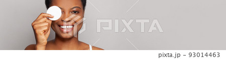 Beauty portrait of a happy cheerful young female face with a cotton pad 93014463