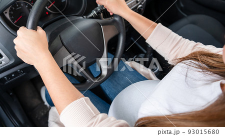 Pregnant woman driver. Beautiful smiling pregnancy woman driving car. Safety pregnant young mother drive concept. 93015680