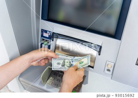 Atm card machine cash. Holding american bill cash. Woman withdraw money usd hundred dollar. Bank credit card money background. 93015692