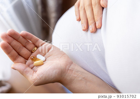 Pregnant woman pills vitamin. Happy smiling woman taking pill with supplement vitamin Omega 3. Vitamin D, E, A Fish Oil Capsules. Pregnant woman pills vitamin. Happy smiling woman taking pill with supplement vitamin Omega 3. Vitamin D, E, A Fish Oil Capsules. 93015702