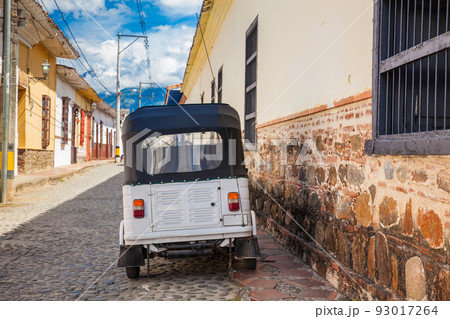 Traditional motorcycle at the beautiful antique streets of the colonial town of Santa Fe de Antioquia in Colombia Traditional motorcycle at the beautiful antique streets of the colonial town of Santa Fe de Antioquia in Colombia 93017264