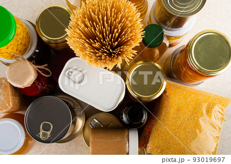 Emergency survival food set on white kitchen table high angle view 93019697