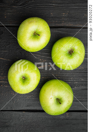 Ripe green apples, on black wooden table background, top view flat lay Ripe green apples, on black wooden table background, top view flat lay 93020272