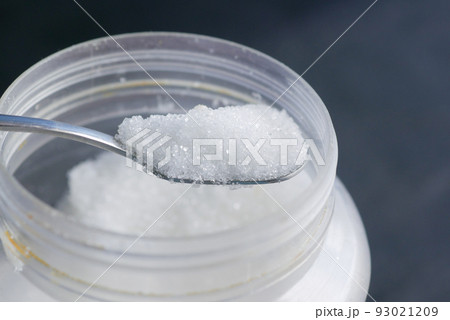 white sugar and spoon in a container on black background, white sugar and spoon in a container on black background, 93021209