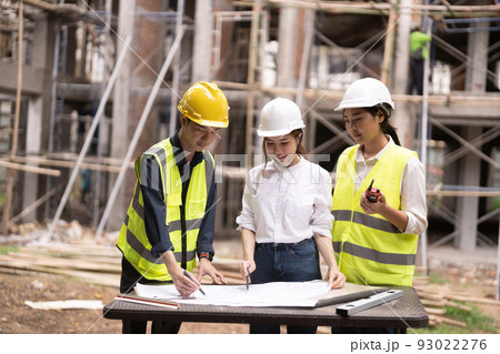 Young asian inspectors and architects discuss with head engineer about construction project. 93022276