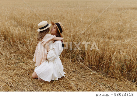 Mom and daughter in a wheat field 93023318