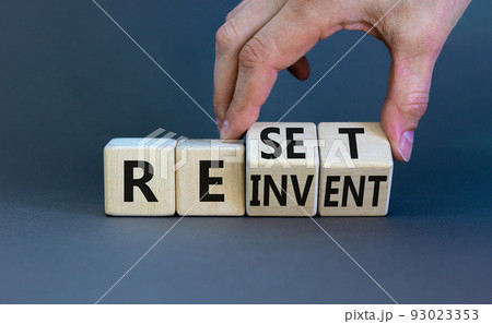 Reinvent and reset symbol. Businessman turns wooden cubes and changes the concept word Reinvent to Reset. Beautiful grey table grey background. Business reinvent and reset concept. Copy space. Reinvent and reset symbol. Businessman turns wooden cubes and changes the concept word Reinvent to Reset. Beautiful grey table grey background. Business reinvent and reset concept. Copy space. 93023353