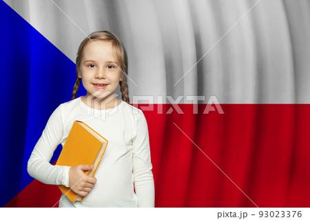Small girl child smiling and holding book  93023376