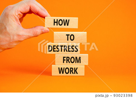 Destress from work symbol. Concept words How to destress from work on wooden blocks. Doctor hand. Beautiful orange background. Psychological business and destress from work concept. Copy space. 93023398