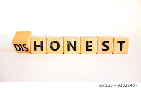 Honest or dishonest symbol. Turned cube and changed the concept word Dishonest to Honest. Beautiful white table white background. Business and honest or dishonest concept. Copy space. Honest or dishonest symbol. Turned cube and changed the concept word Dishonest to Honest. Beautiful white table white background. Business and honest or dishonest concept. Copy space. 93023407
