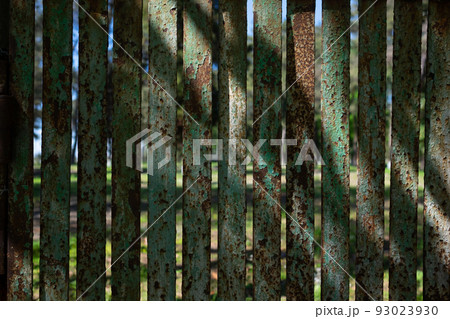 Rusty metal green fence. Background and copyspace. 93023930
