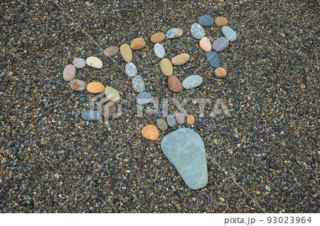 Stone arranged like a footprint on the beach 93023964