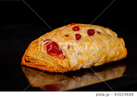 One baked bun with red strawberry jam in electric oven: close up One baked bun with red strawberry jam in electric oven: close up 93024688
