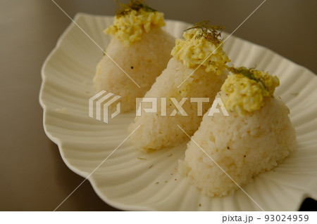Plate with traditional Japanese onigiri with egg on brown background and beautiful white plate with leaf shape 93024959