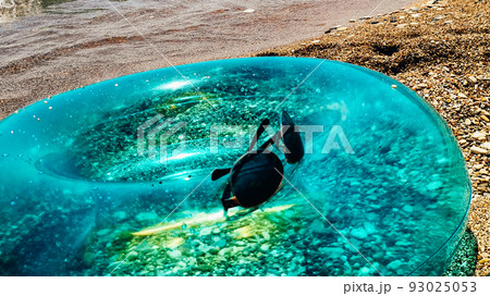 Blue inflatable swim ring float and sunglasses on the beach. Blue inflatable swim ring float and sunglasses on the beach. 93025053