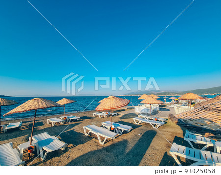 Bamboo beach umbrella on blue sky background Bamboo beach umbrella on blue sky background 93025058