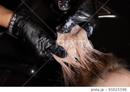 Airtouch Hair stylist makes bouffant using comb on thin strands. Shatush technique for hair lightening. 93025596